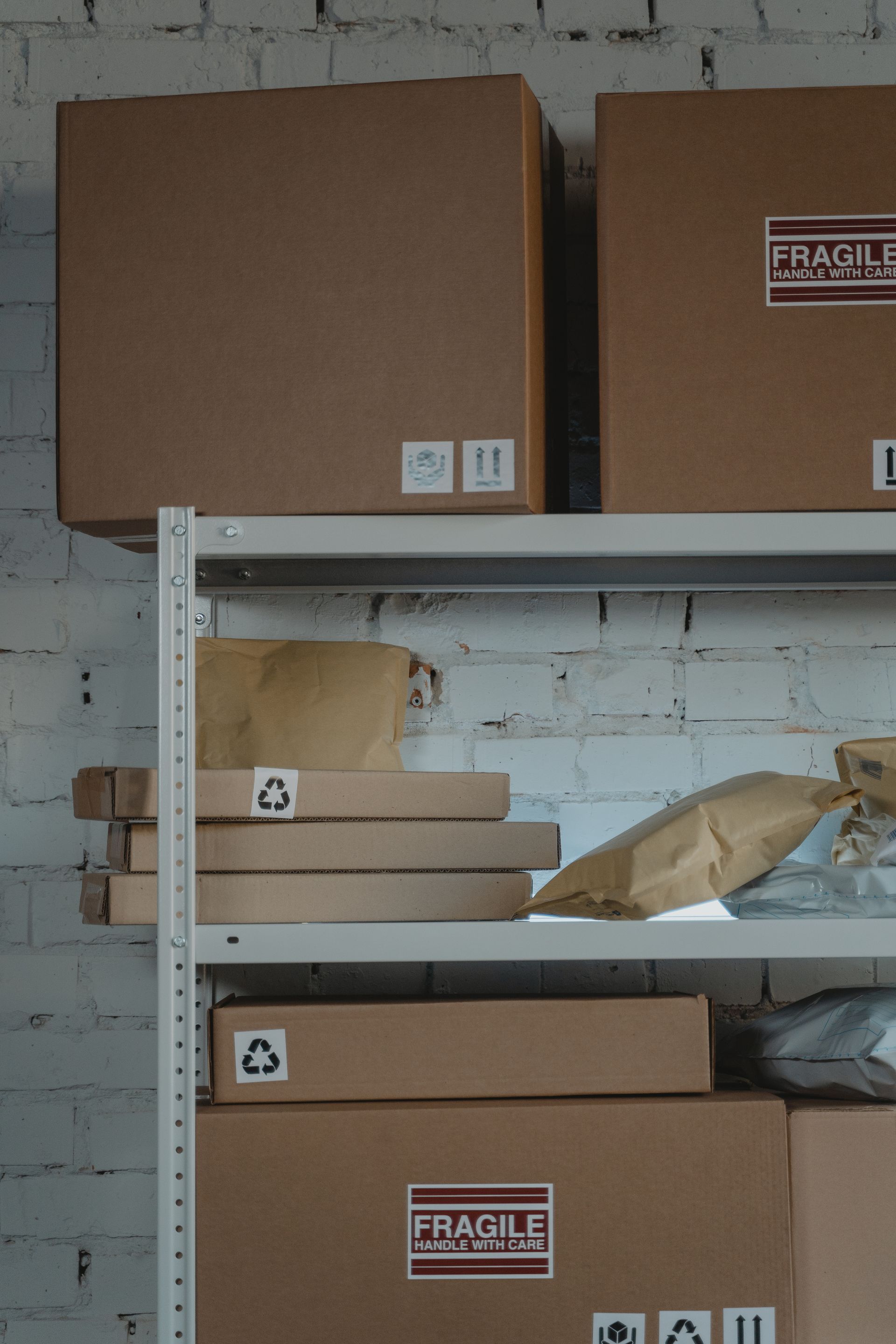Labeled moving boxes on metal shelving in a climate-controlled storage room